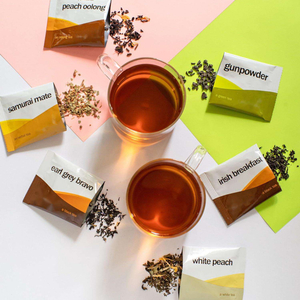Assorted tea bags, including Black and White Peach Irish Breakfast Tea and Green Tea